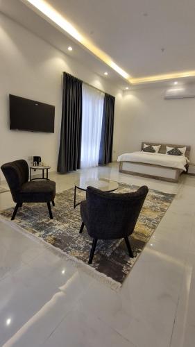a living room with a bed and a table and chairs at Elizabeth in Muscat