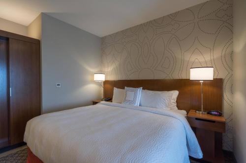 a hotel room with a large bed with two lamps at Fairfield Inn & Suites by Marriott Lubbock Southwest in Lubbock