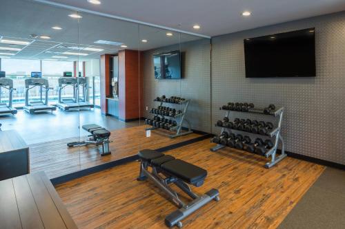 a gym with dumbbells and a flat screen tv at Fairfield Inn & Suites by Marriott Lubbock Southwest in Lubbock