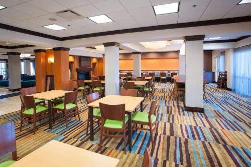 a dining room with tables and chairs at Fairfield Inn & Suites Orange Beach in Orange Beach