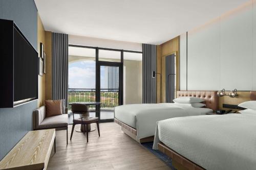 a hotel room with two beds and a balcony at Four Points by Sheraton Huzhou, Nanxun in Huzhou