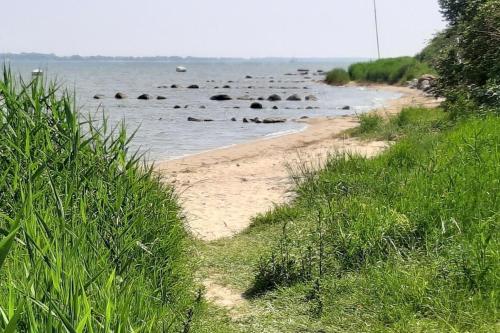 a beach with a group of rocks in the water at Wellenreiter in Stahlbrode