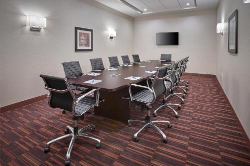 a conference room with a long table and chairs at Four Points by Sheraton Sherwood Park in Sherwood Park