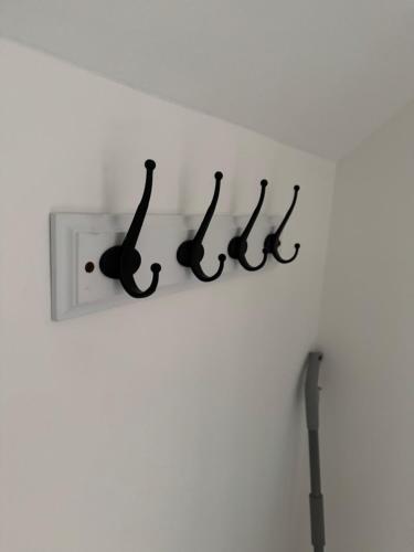 a white wall with a shelf with black musical notes at Harmony House 3 Bedroom New Build for Families, Contractors, Black Country Museum Sleeps 6 in Tipton