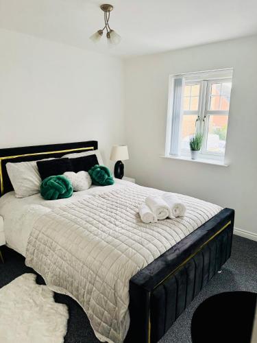 a bedroom with a large bed with towels on it at Harmony House 3 Bedroom New Build for Families, Contractors, Black Country Museum Sleeps 6 in Tipton