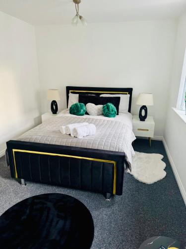 a bedroom with a bed with towels on it at Harmony House 3 Bedroom New Build for Families, Contractors, Black Country Museum Sleeps 6 in Tipton