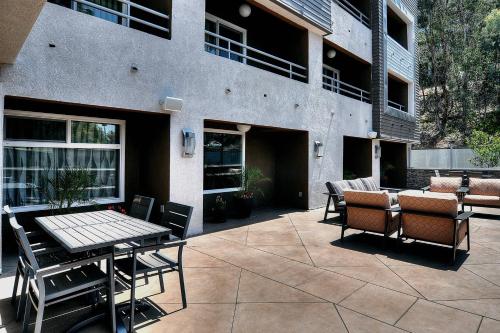 a patio with a table and chairs in front of a building at Fairfield Inn & Suites by Marriott Los Angeles Rosemead in Rosemead