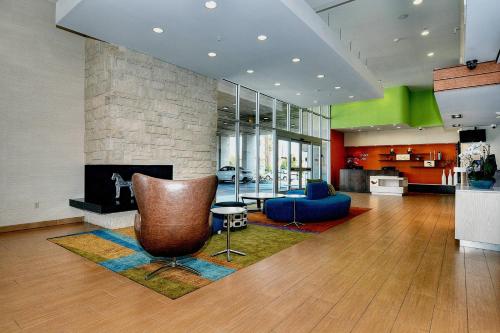 a living room with a chair and a fireplace at Fairfield Inn & Suites by Marriott Los Angeles Rosemead in Rosemead