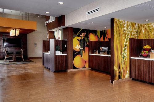 a lobby of a hotel with a painting on the wall at Fairfield Inn & Suites by Marriott Los Angeles Rosemead in Rosemead
