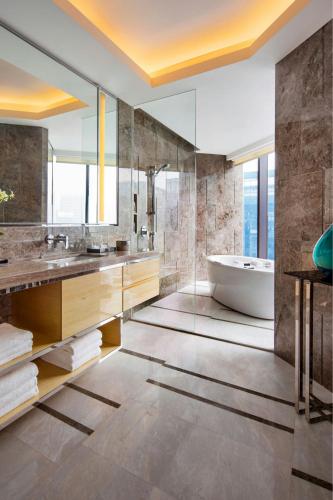 a bathroom with a tub and a sink at JW Marriott Hotel Chengdu in Chengdu