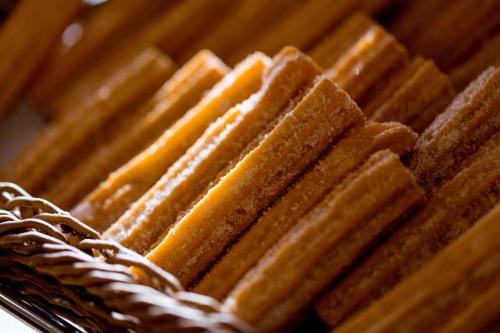 a pile of breads on a basket with cheese at JW Marriott Cancun Resort & Spa in Cancún
