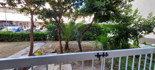 a balcony with a white fence and trees at Apartman Tivat - Centar 1 in Tivat