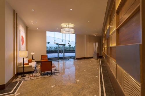 a lobby with a large window and a living room at Four Points By Sheraton Visakhapatnam in Visakhapatnam