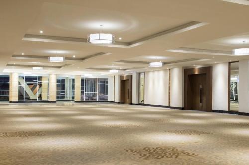 a large empty room with a large ballroom with columns at Four Points by Sheraton Makassar in Makassar