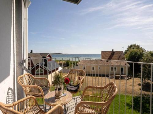 a balcony with a table and chairs and the ocean at Small Double Room at Hanohus Hotel in Sölvesborg