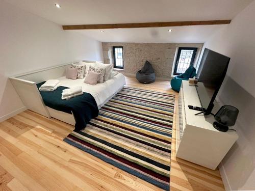 a bedroom with a large bed and a rug at Villa Eleonore - Chic Central Retreat Heated Pool in Monségur