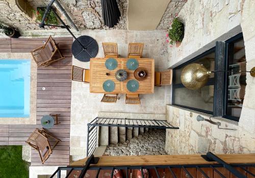 a wall with a table and chairs on it at Villa Eleonore - Chic Central Retreat Heated Pool in Monségur