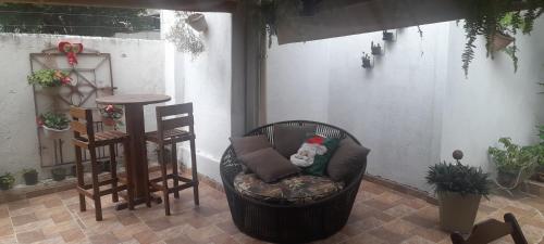 a chair with a teddy bear sitting on a patio at Hospedagem da Néli in Aparecida