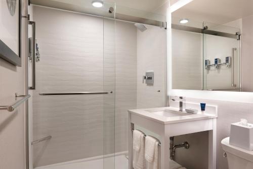 a bathroom with a shower and a sink at Four Points by Sheraton Windsor Downtown in Windsor