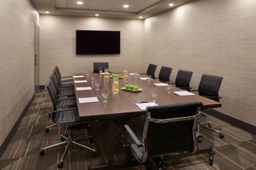 a conference room with a large table and chairs at Four Points by Sheraton Windsor Downtown in Windsor