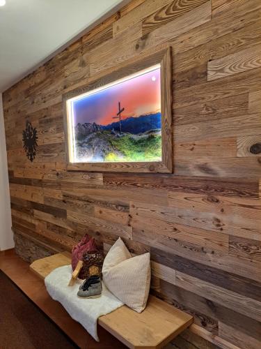 a room with a wooden wall with a window at Haus Angelika im Zillertal in Hippach