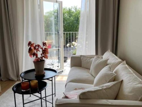 a living room with a couch and a table with a plant at Studio with Terrace in Sölvesborg in Sölvesborg