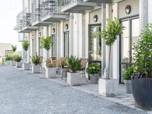 a row of potted plants on the side of a building at Suite with sea view in Sölvesborg in Sölvesborg