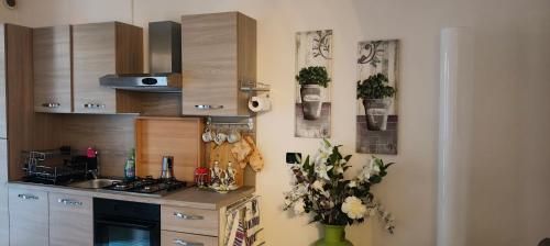 a kitchen with a sink and a stove top oven at La Casa al Mare di Rossella in Cavallino-Treporti
