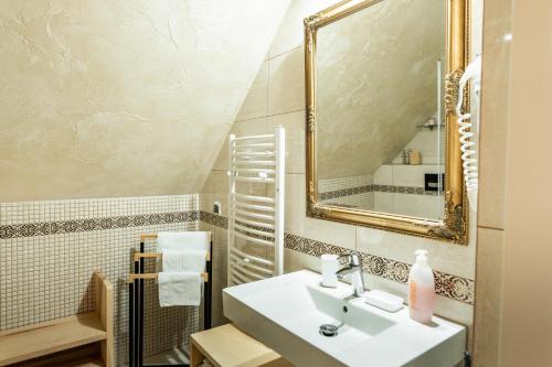 a bathroom with a sink and a mirror at Apartament U Moniki in Szaflary
