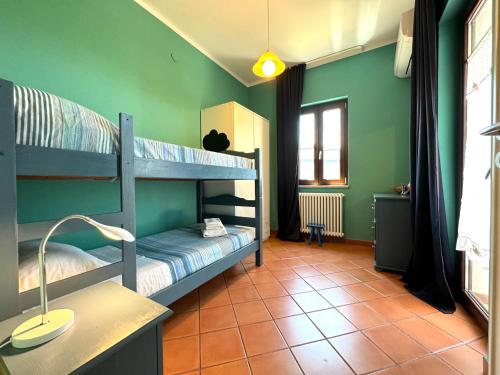 two bunk beds in a green room with a lamp at Casa di Mami in Capaci
