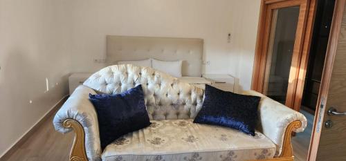 a couch with two pillows on it in a bedroom at Villa luxueuse in Agadir