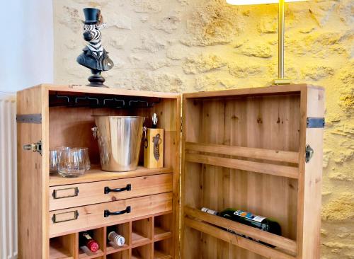 a wooden cupboard with a lamp on top of it at Villa Eleonore - Chic Central Retreat Heated Pool in Monségur