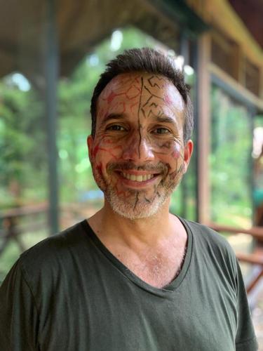 a man with a face painting on his face at Casa Amazonas in Puerto Maldonado