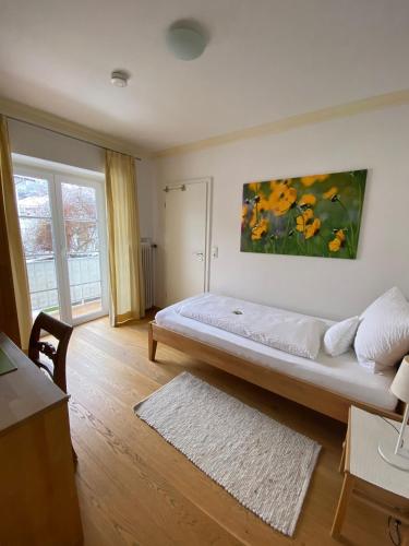 a bedroom with a bed with a painting on the wall at Haus Sibylle in Bad Tölz
