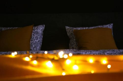 a bed with some lights on top of it at Industrial Apartment in Kula