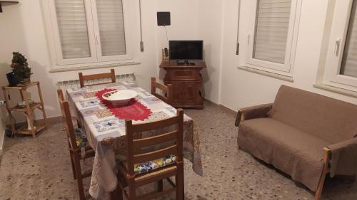 a living room with a table and a couch at Amelia Sweet Home - Farindola in Farindola