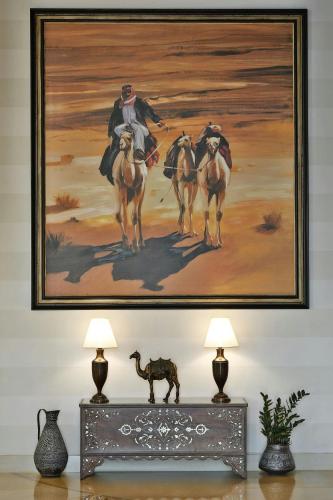 a painting of three horses on a wall at Al Manara, a Luxury Collection Hotel, Aqaba in Aqaba