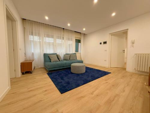 a living room with a couch and a blue rug at Lake Lovers House in Lesa