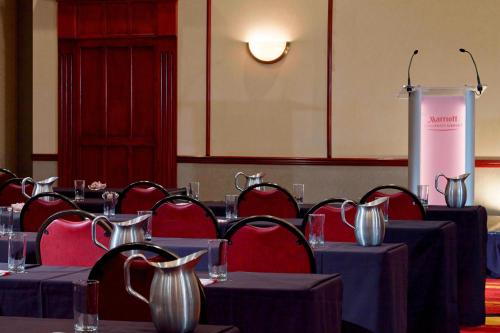 a conference room with tables and chairs and a podium at Marriott Cincinnati Airport in Hebron