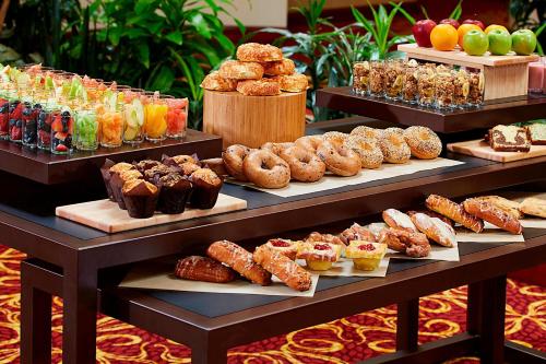 a display case with different types of pastries and desserts at Marriott Cincinnati Airport in Hebron