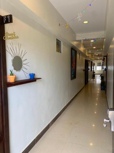 a hallway in a hospital with a white wall at Louis' Apartments in Placencia Village