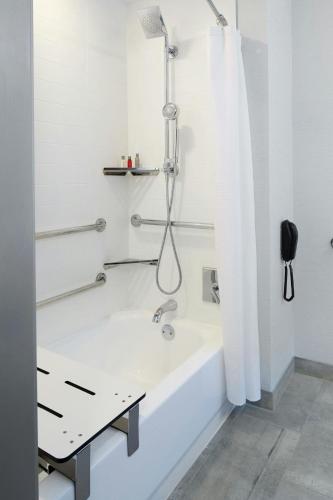 a bathroom with a bath tub with a shower at Marriott Cincinnati North in West Chester