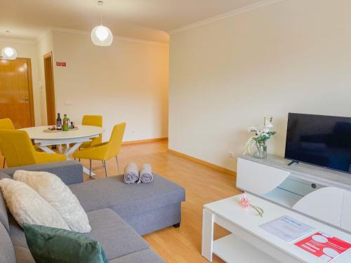 a living room with a couch and a table at Sandie's Serene Stay in Caniço