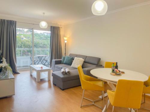 a living room with a couch and a table at Sandie's Serene Stay in Caniço