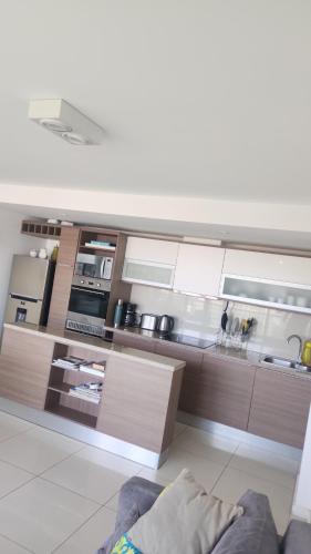 a large kitchen with wooden cabinets and appliances at Gala Vista in Punta del Este