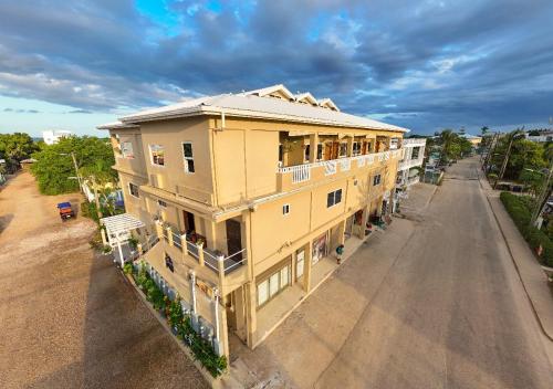an overhead view of a yellow building on a street at Louis' Apartments in Placencia Village