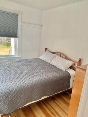 a bedroom with a bed and a window at Nautical Beach Apartments in Hampton