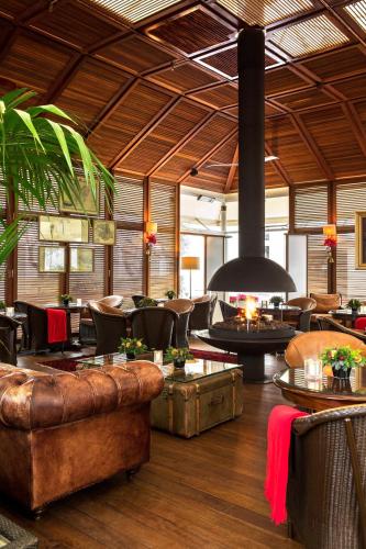a restaurant with leather furniture and a large fireplace at Hotel Grande Bretagne, a Luxury Collection Hotel, Athens in Athens