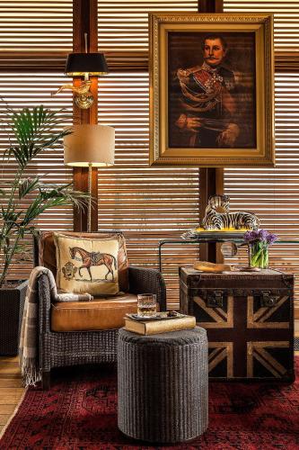 a living room with a chair and a painting on the wall at Hotel Grande Bretagne, a Luxury Collection Hotel, Athens in Athens