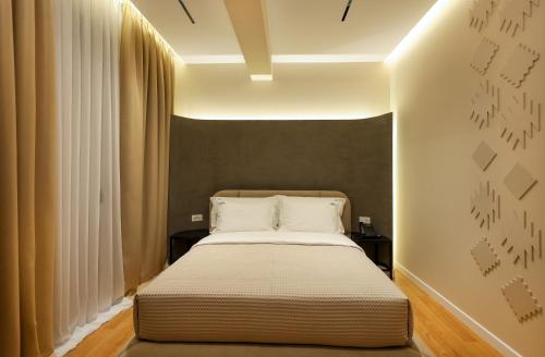 a bedroom with a bed with white pillows at Beratinus1 in Berat